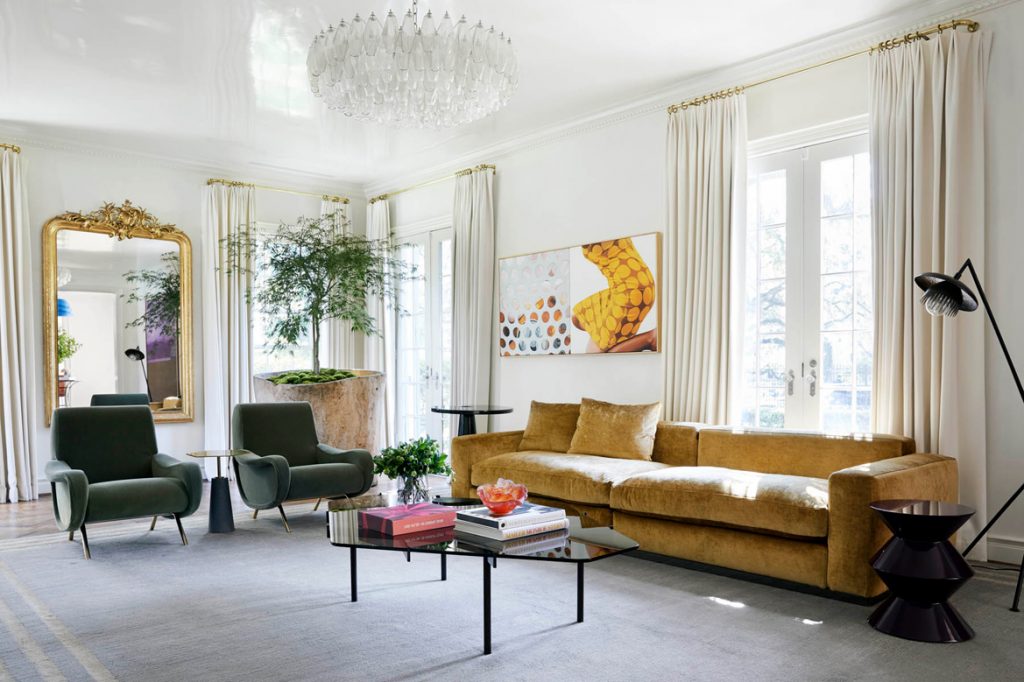 Living room with long sofa, lamp armchairs and glass coffee table