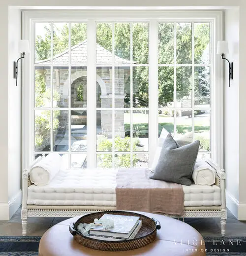 Wide windows, sofa and coffee table in the corner of the living room