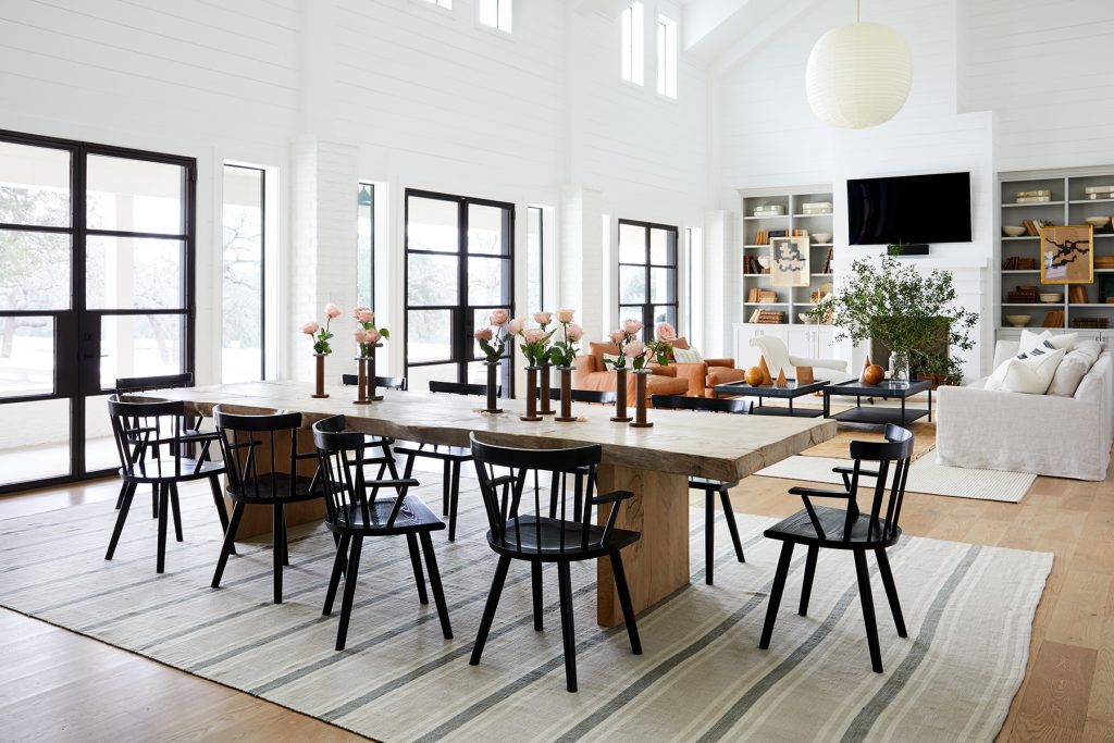 Living room with dining table and dark wooden chairs around it