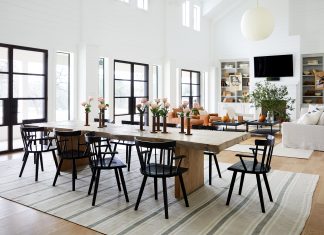 Living room with dining table and dark wooden chairs around it