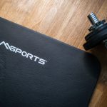 Workout mat and a dumbbell in home gym
