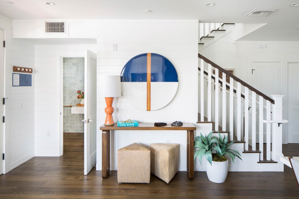 Hall with staircase and a desk with decorations