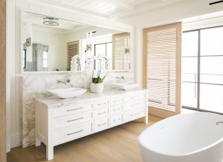 Bathroom with tub and sinks