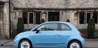 Blue Fiat car in front of the house