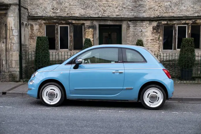 Blue Fiat car in front of the house