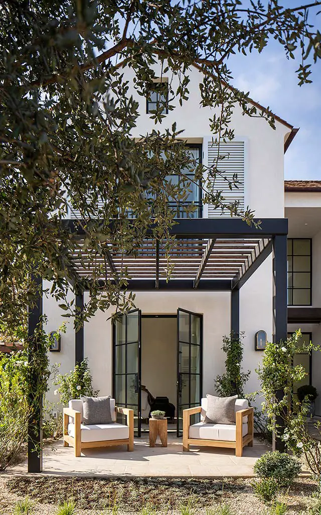 Porch with arm chairs and glass doors in the yard