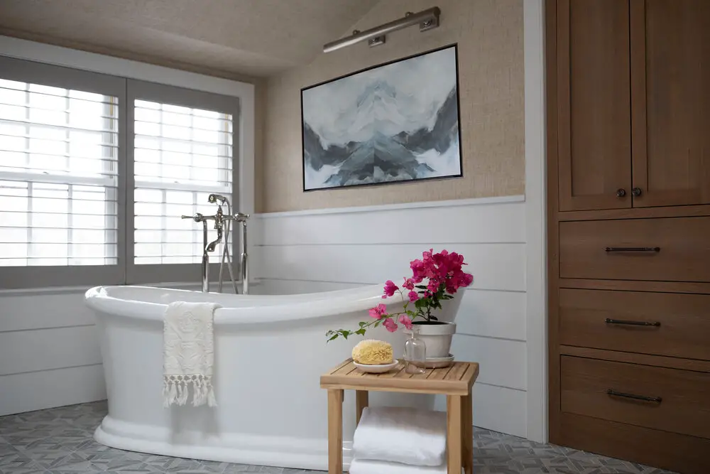 Bathroom with a tub and a vase with flowers