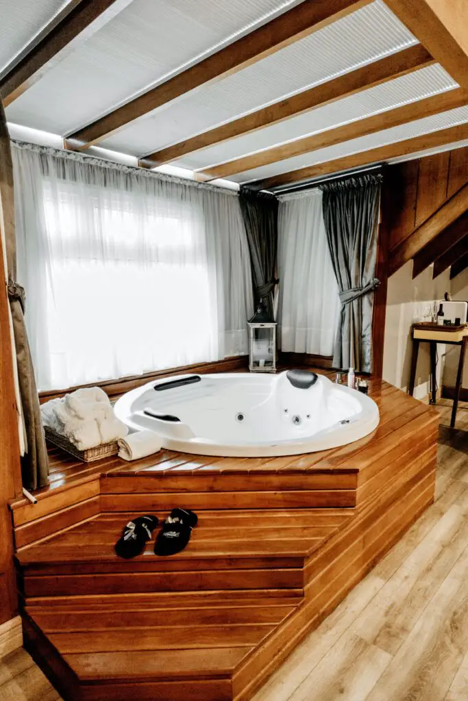 Hot tub in bathroom with wooden floor