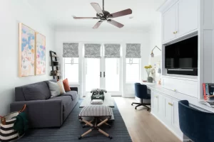 Living room with gray sofa, dark coffee table and wide windows