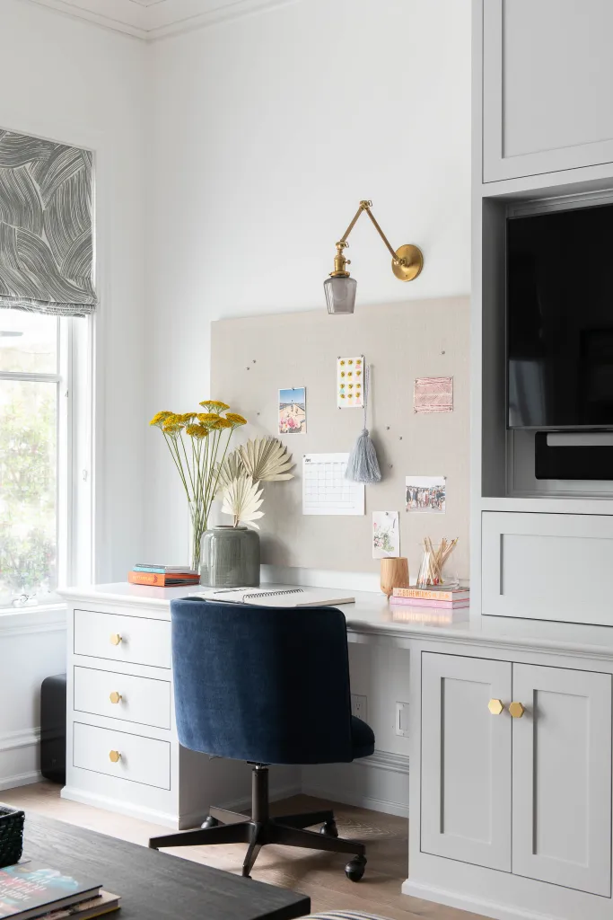 Home office with desk, chair and flowers in a vase