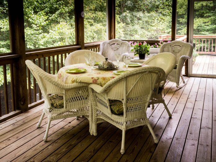 Porch with decking and white table and chairs