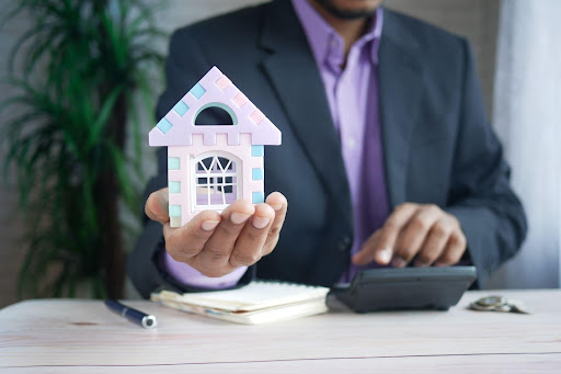 Man holding a small plastic house